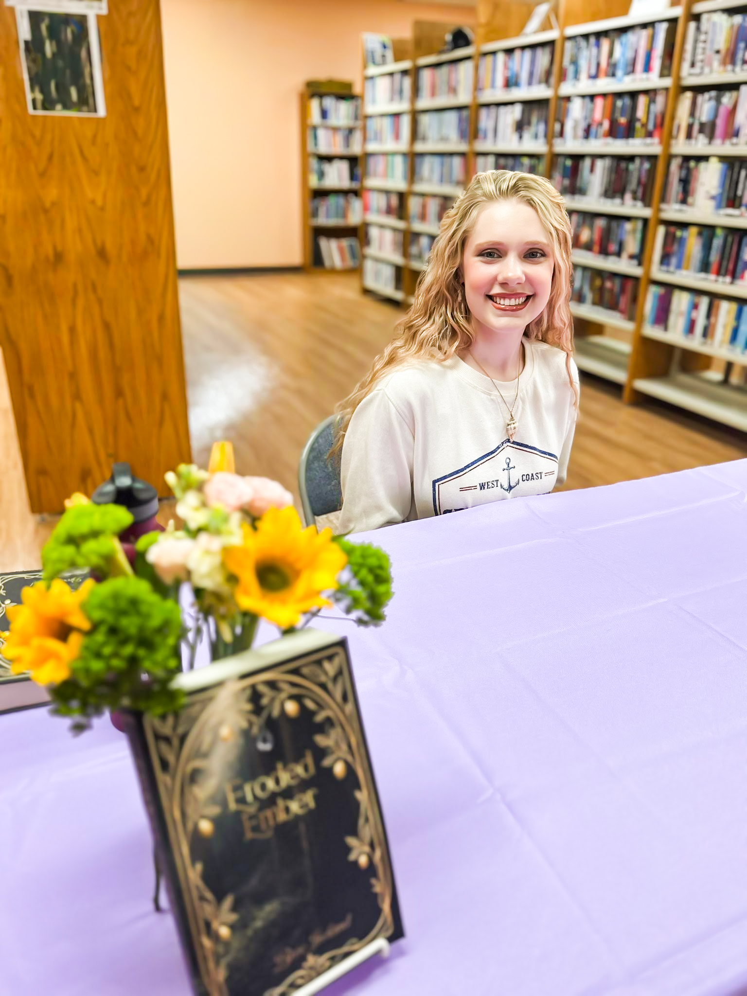 Bree Ireland at book signing event for Eroded Ember debut novel